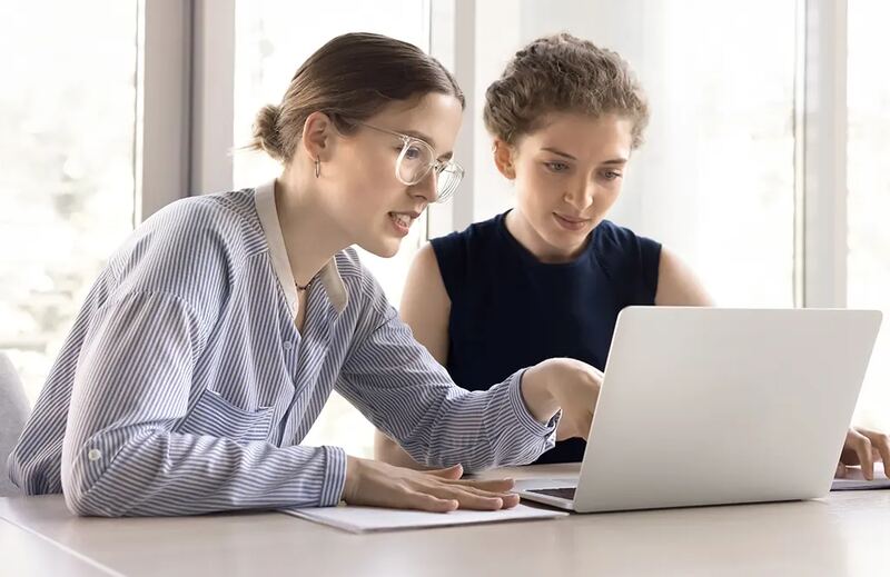 Two colleagues working together at a laptop