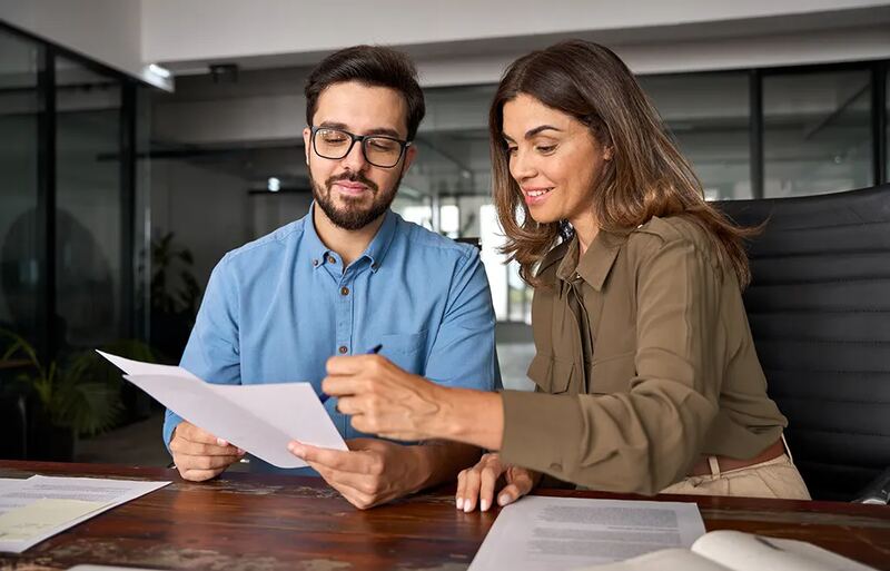 Two colleagues reviewing a document together