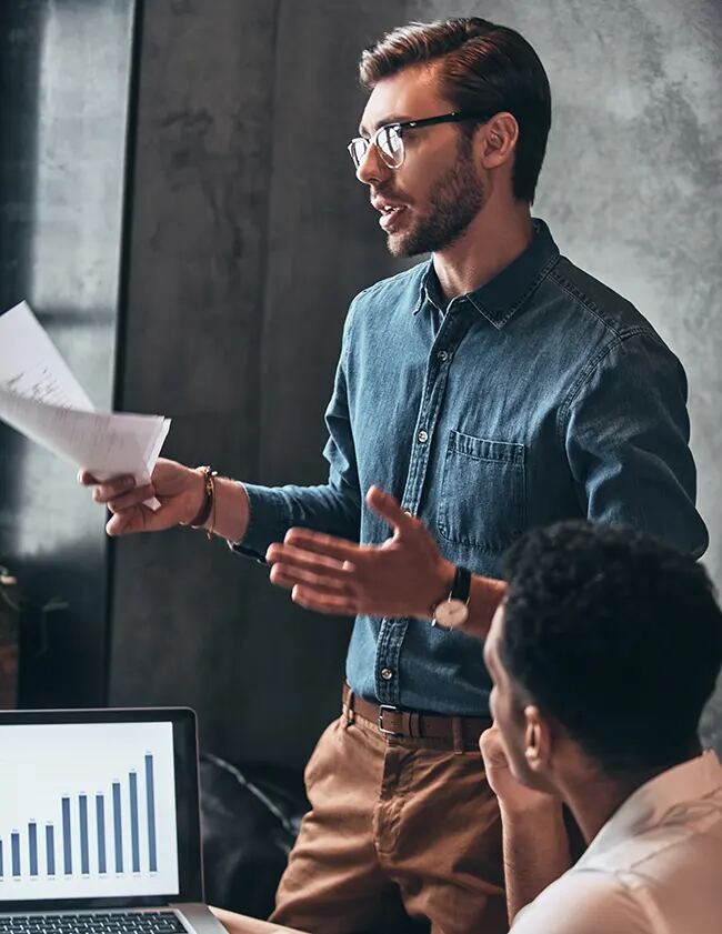 A presenter explaining a chart to colleagues