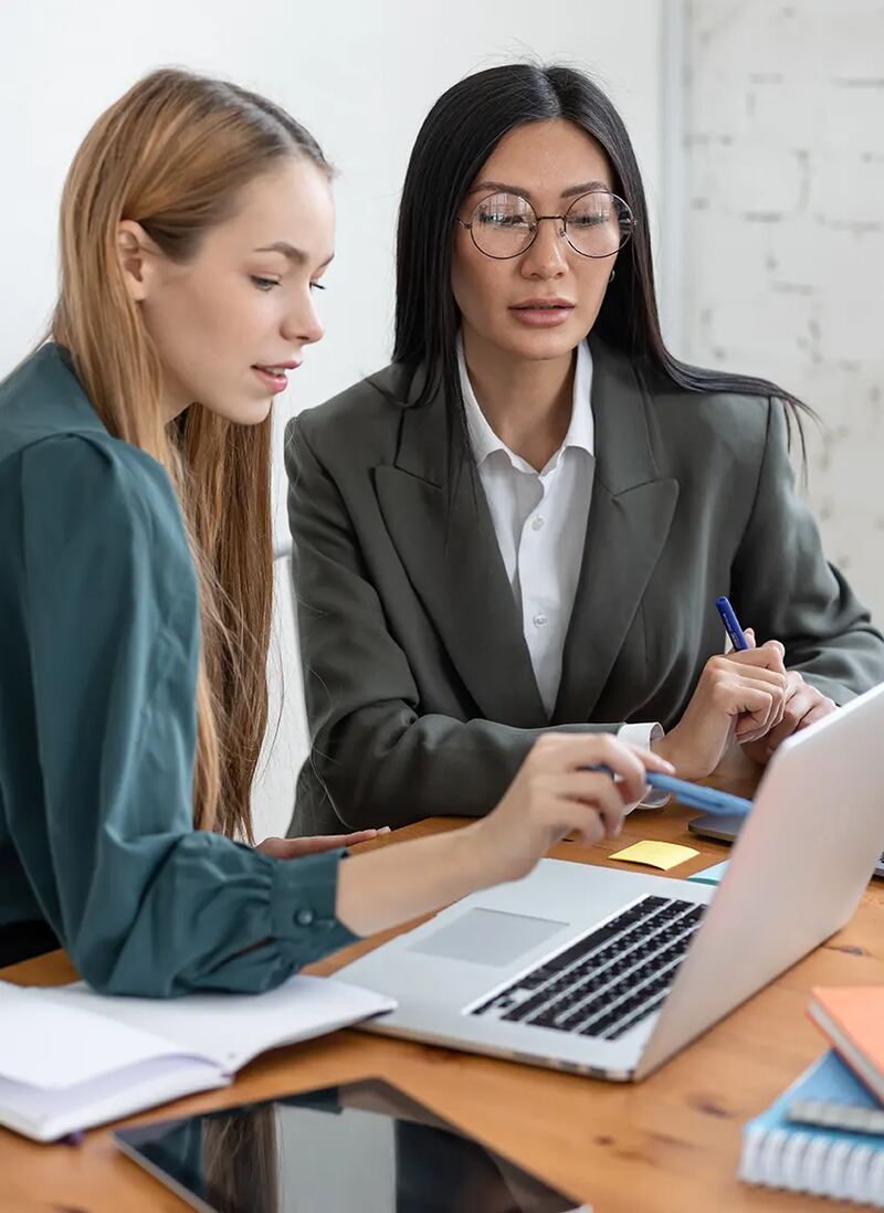 Two colleagues working together at a laptop