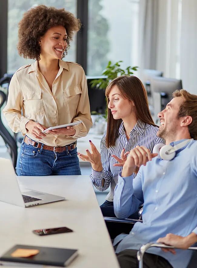 Colleagues smiling during a meeting in a bright office