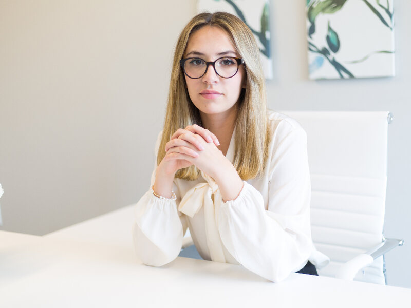 An administrator working at a desk in a bright office