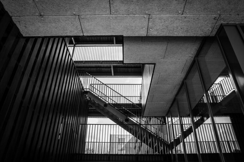 Geometric concrete staircase seen from below, suggesting structured advancement