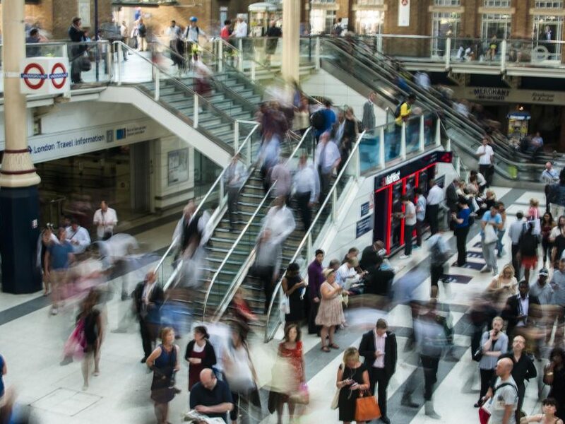 Representatives moving through a busy retail concourse during a campaign