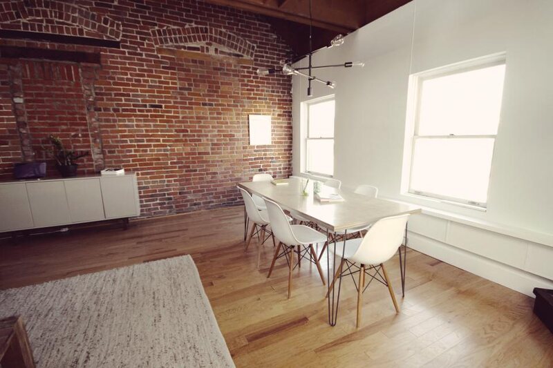 A bright open-plan office with a meeting table