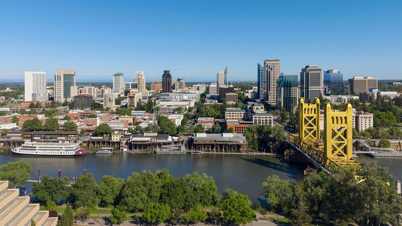 Downtown Sacramento skyline with the Tower Bridge crossing the Sacramento River at midday