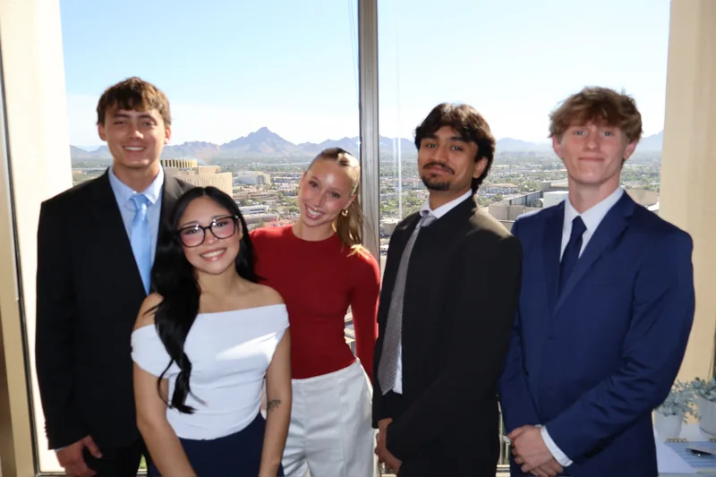 RAD team members in front of the office window with mountain views