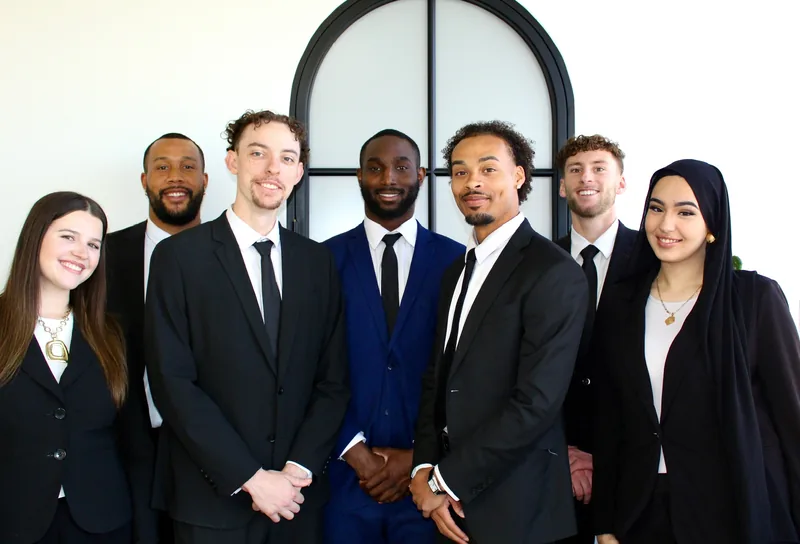 RAD team members together by the arched office window