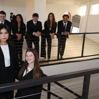 RAD team members gathered on the office staircase and mezzanine