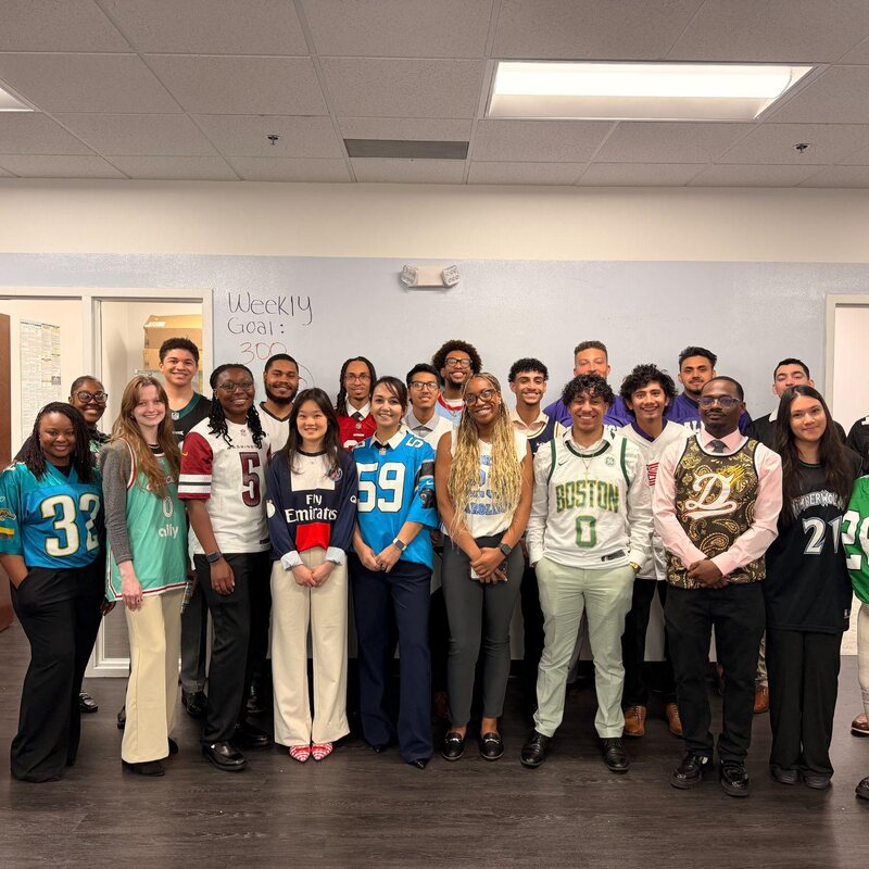 TriMkt team wearing sports jerseys for a team theme day at the office
