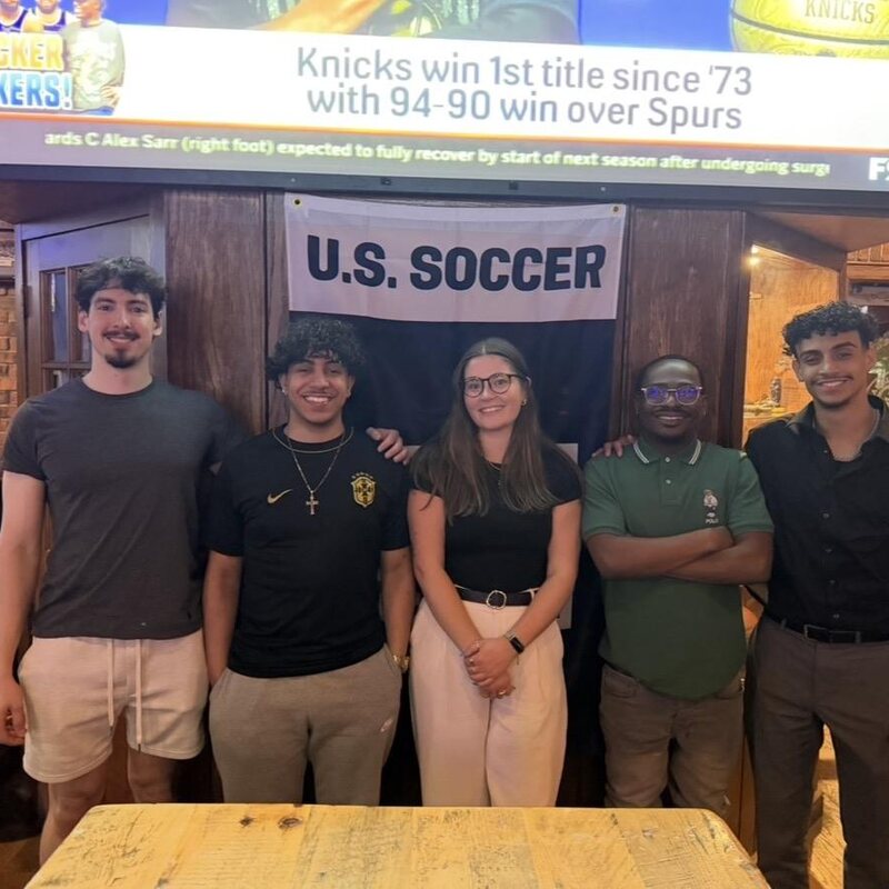 TriMkt team members watching a game together at a local restaurant