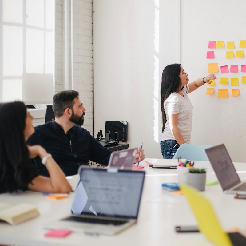 Team planning a campaign with sticky notes on a whiteboard