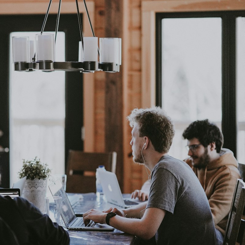 Team members chatting in a bright, relaxed workspace