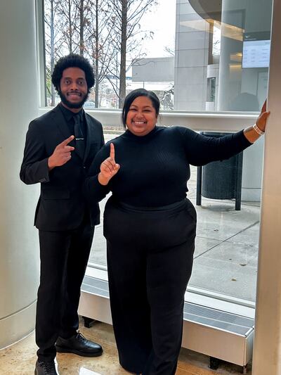 Two Capacity Expansion Co team members in professional attire at a company event
