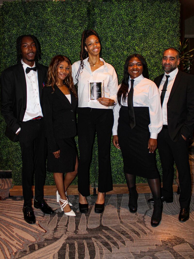 The Capacity Expansion Co team holding an award at a company recognition event