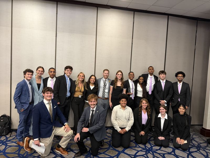 Large group photo of the Clarity Acquisitions team at a company event