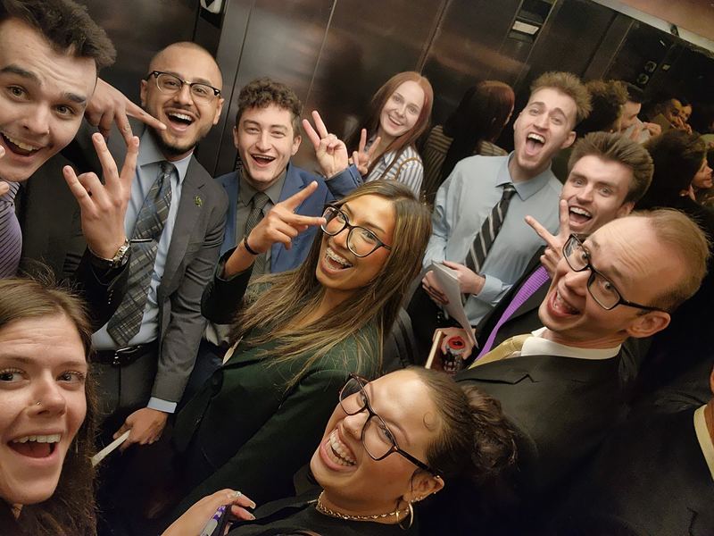 Clarity team members laughing together in an elevator