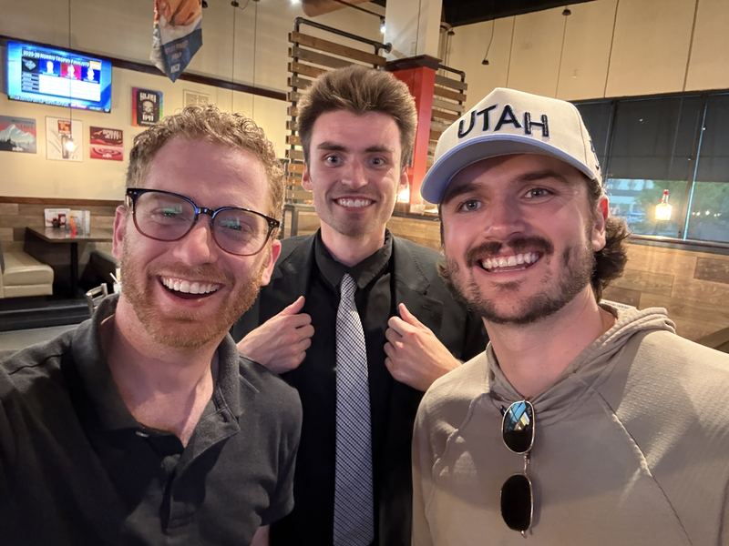 Dustin Harward with two team members at a team night out