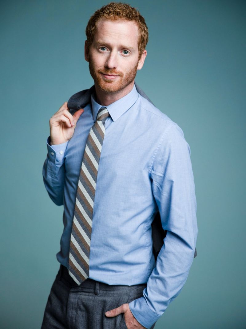 Dustin Harward, CEO and founder of Clarity Acquisitions, in a blue shirt and tie