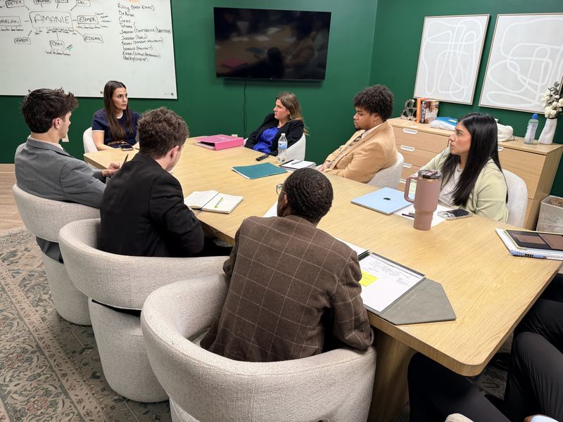 Clarity leaders meeting around a conference table to review campaign results