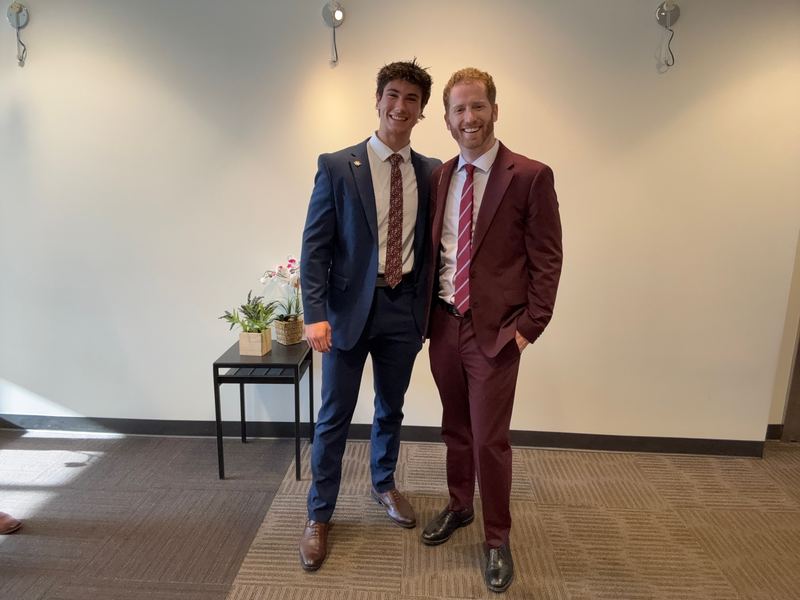 Dustin Harward celebrating a team member's promotion at the Clarity Acquisitions office