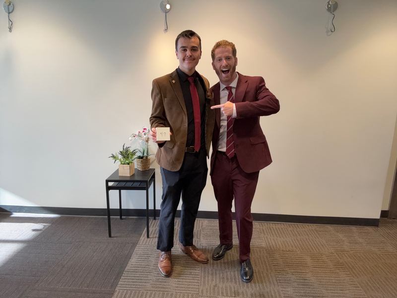 A Clarity team member celebrating a milestone with Dustin Harward