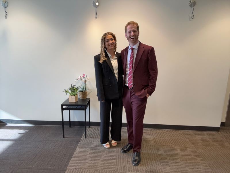 A newly promoted Clarity leader standing with Dustin Harward in the office