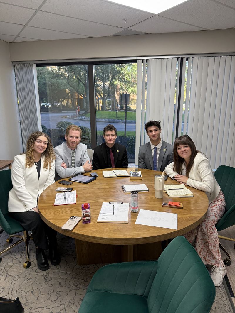 Team members around a round table during a coaching session
