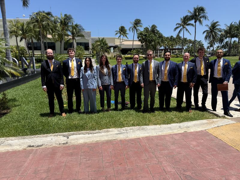 The Clarity team in suits outdoors on a sunny day