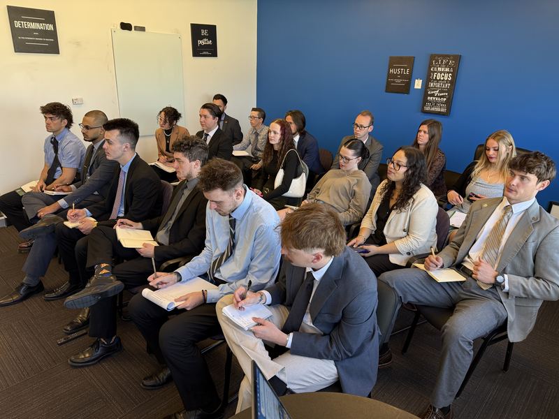 Clarity team members taking notes during a morning training session