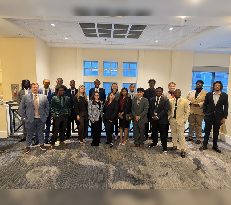 The Embark Consulting Inc. team in business attire gathered for a group photo in the office