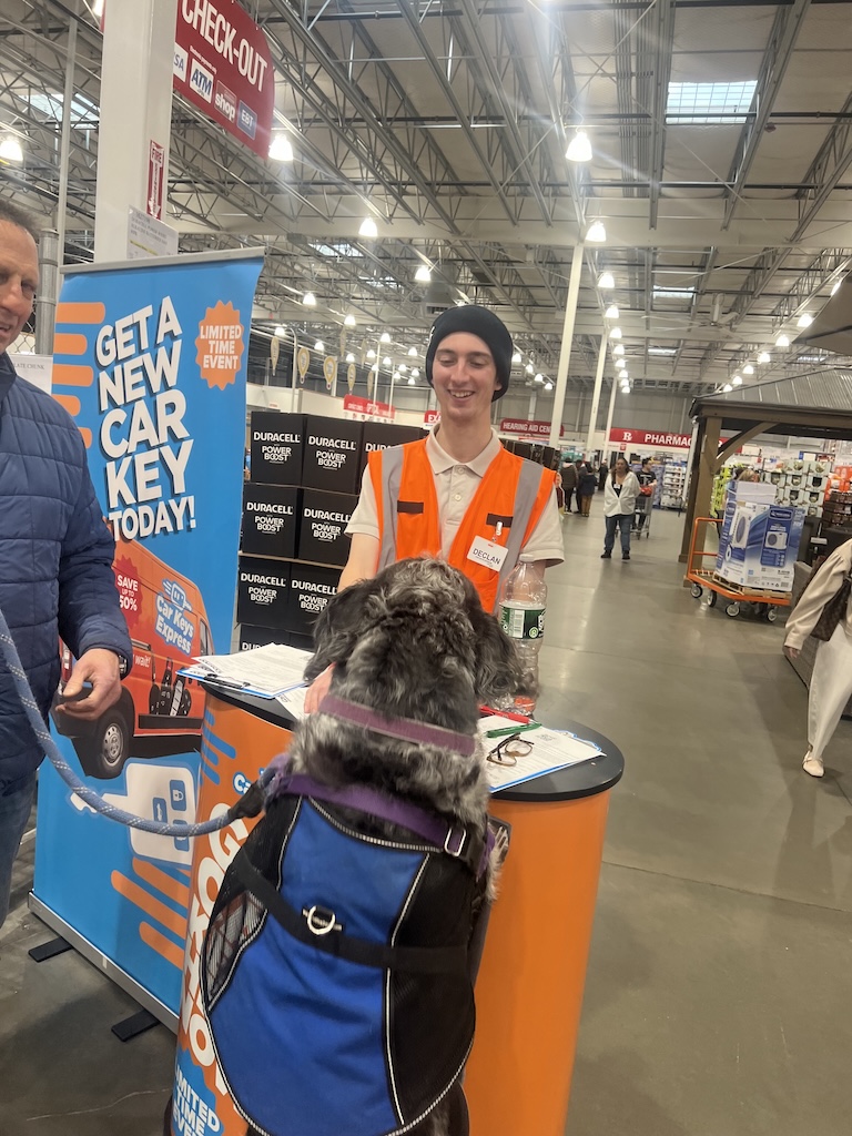 GAF Solutions in-store specialist at a retail kiosk engaging a customer