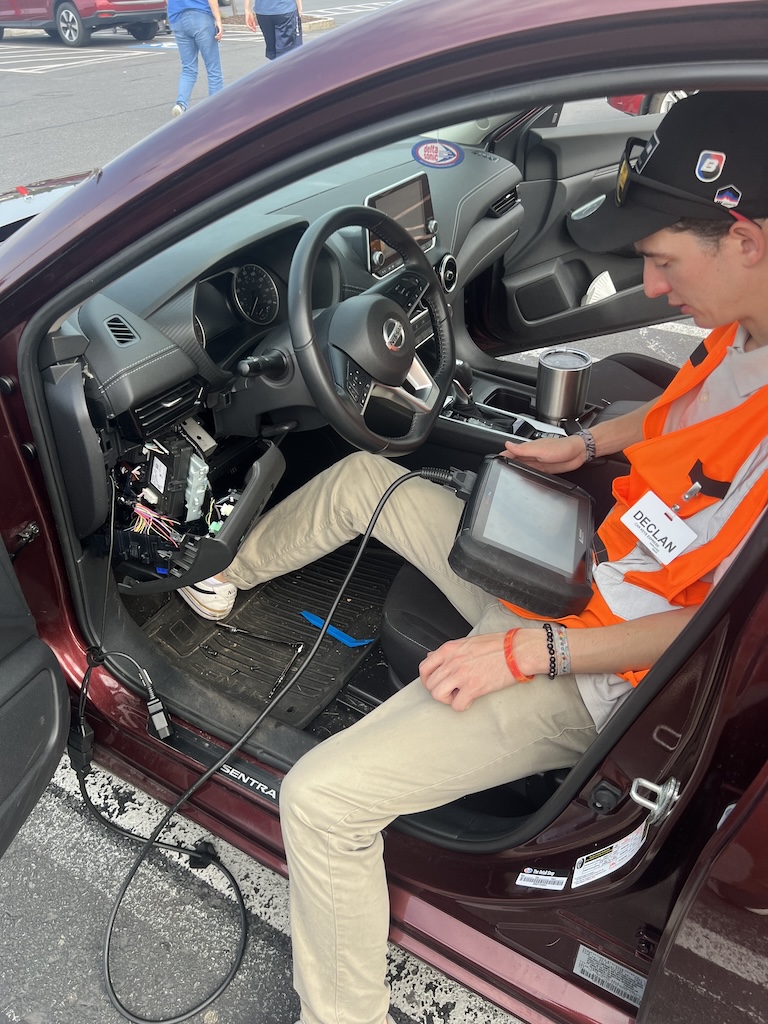 Specialist performing diagnostic key programming inside a vehicle