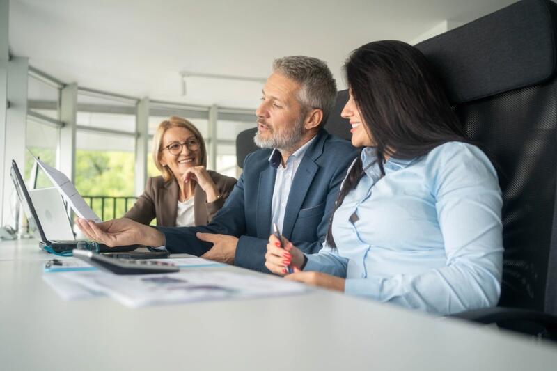Professionals in a meeting around a desk