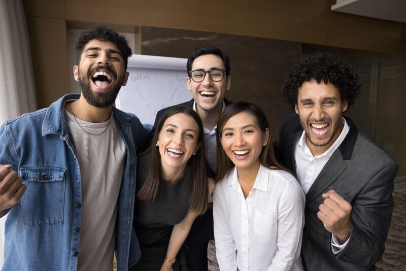 Smiling JDM Elite team members celebrating together