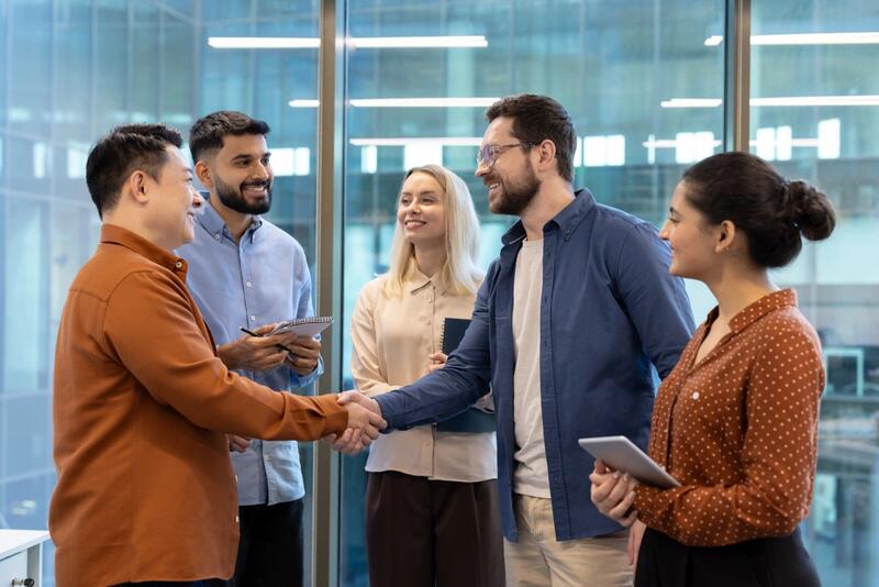 Colleagues shaking hands in a bright office