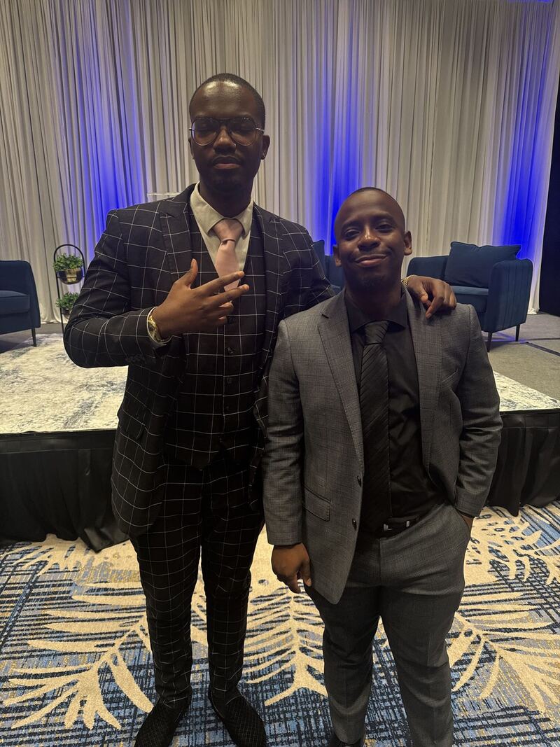 Two Kalispell Concepts leaders in suits at a conference
