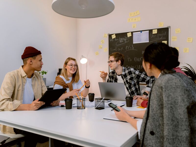 Colleagues collaborating around a table during a team meeting