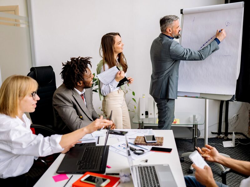 A trainer leading a development session at a whiteboard