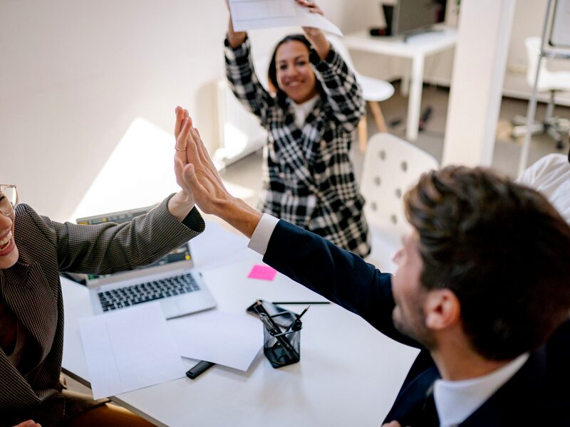 Coworkers celebrating together in an open-plan office