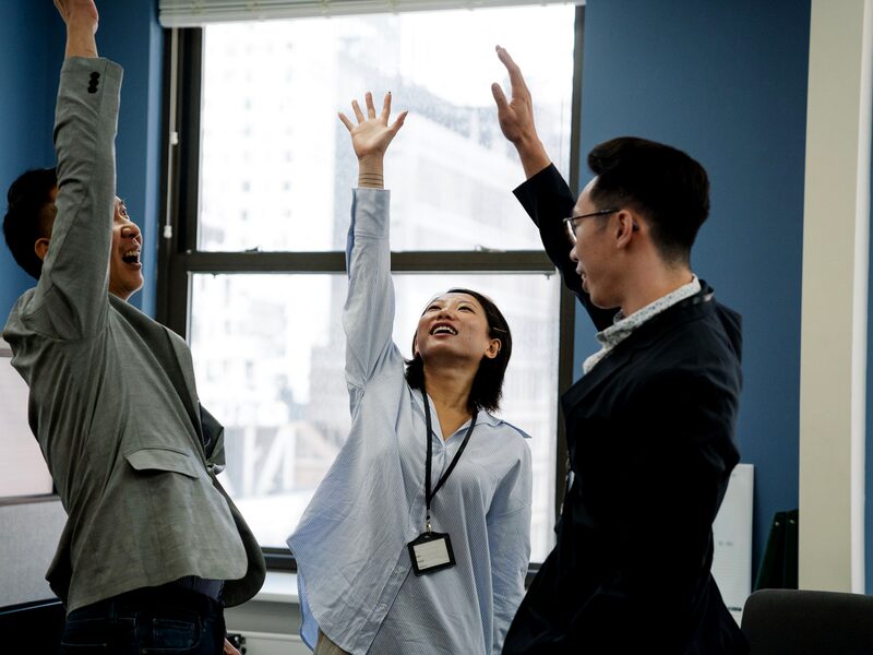 Team members cheering together after hitting a goal