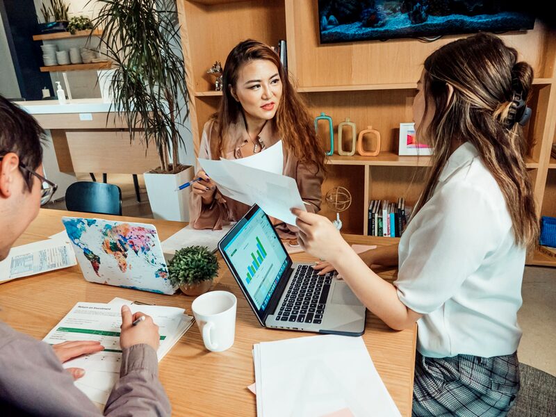 A small team working together over laptops and notes