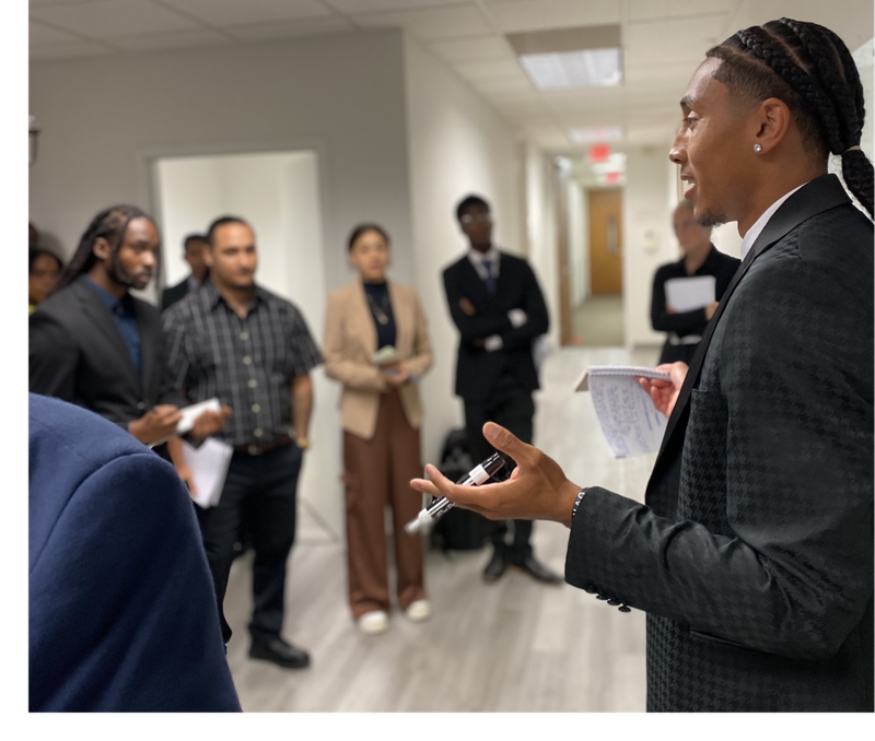 A Mission III Management leader speaking with team members during a collaborative discussion