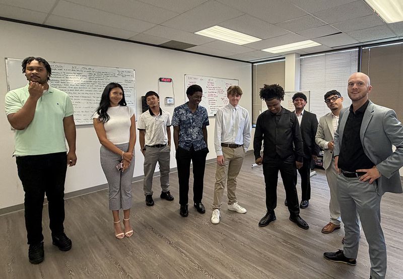 Mission III Management team members gathered for a training session
