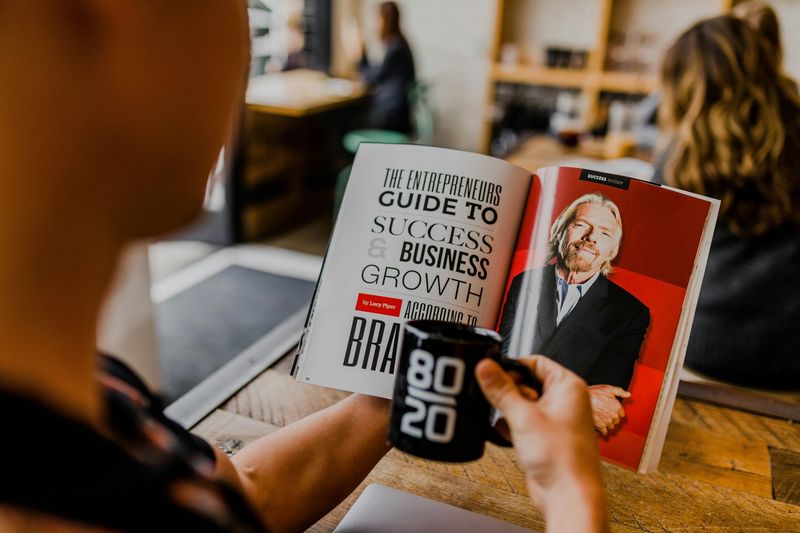 man reading book about client acquisition in business