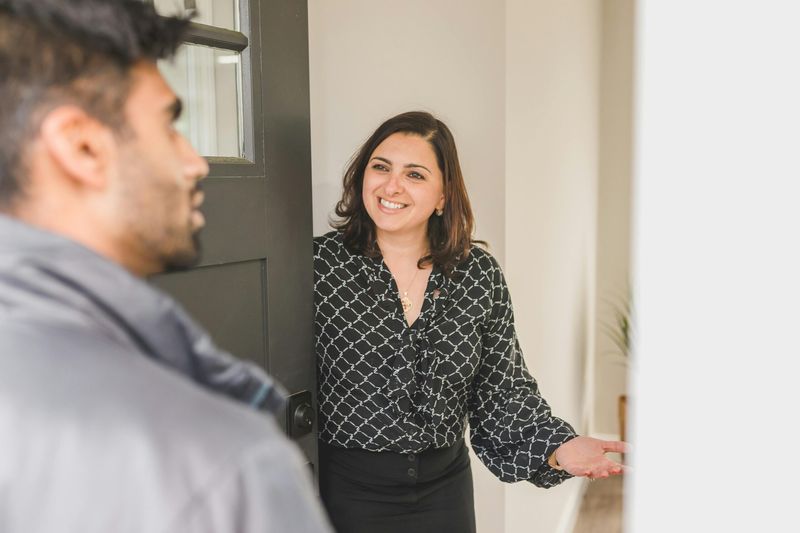 Door-to-door salesperson with a client