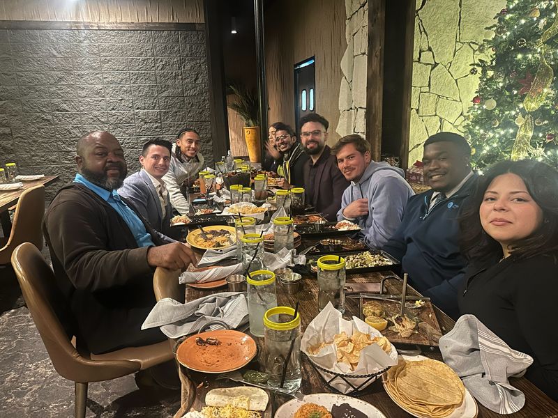 Mission III Management team sharing a celebratory meal