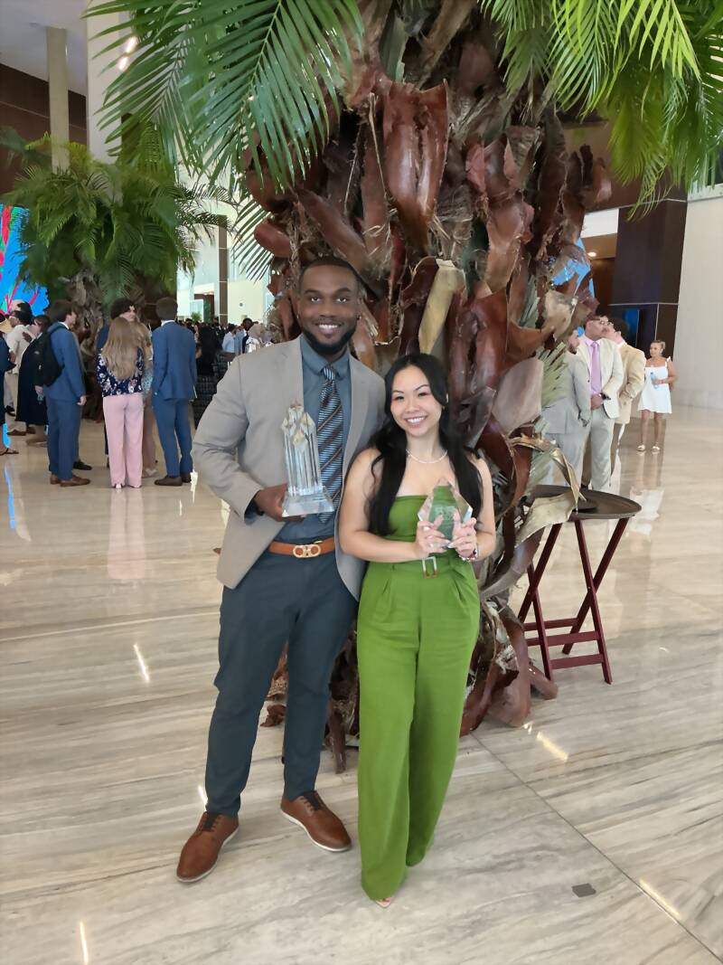 New Acquisitions team members holding awards at an industry recognition event