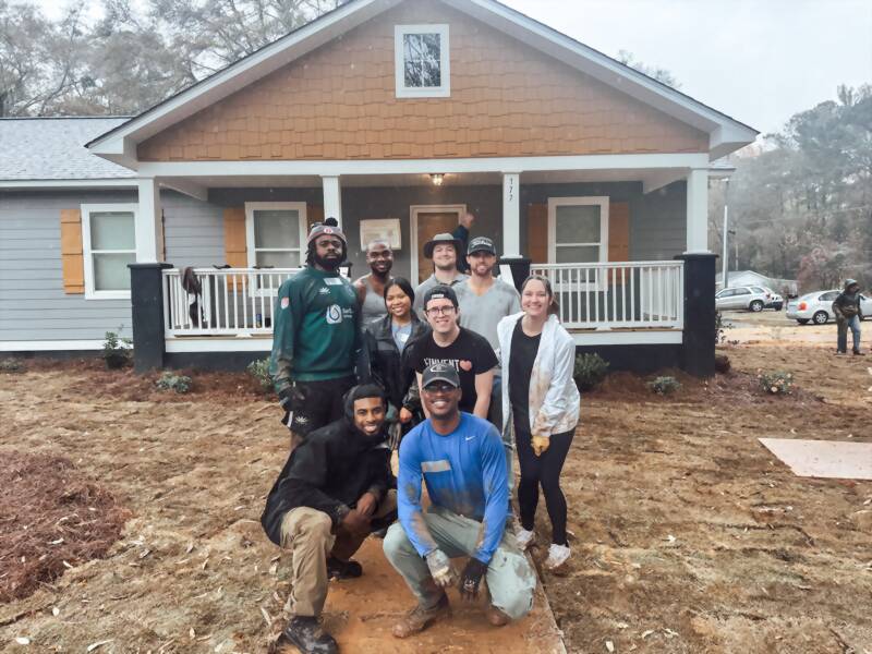 New Acquisitions volunteers at a Habitat for Humanity home build site
