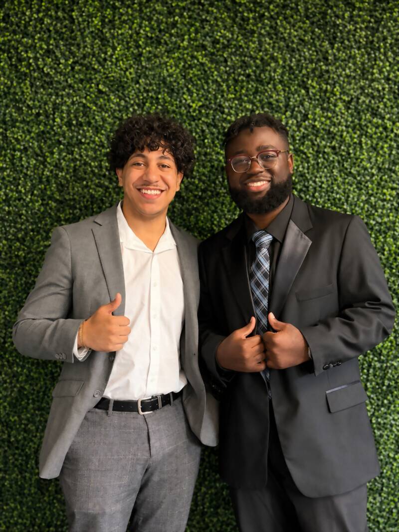 Two New Acquisitions team members celebrating at a company event